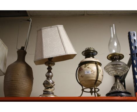 A FLORAL CERAMIC OIL LAMP WITH DUPLEX BURNERS TOGETHER WITH A GLASS EXAMPLE