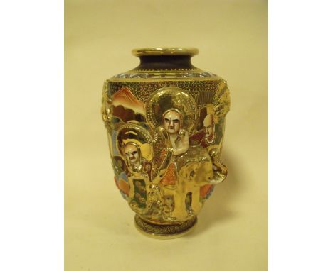 A JAPANESE CERAMIC FIGURAL VASE WITH ORNATE RELIEF