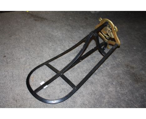 A BRASS AND CAST METAL HORSE SADDLE RACK TOGETHER WITH A BRASS STICK STAND