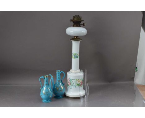 A pair of 19th century turquoise glass rose water jugs, together with a large white glass opaque oil lamp painted with floral