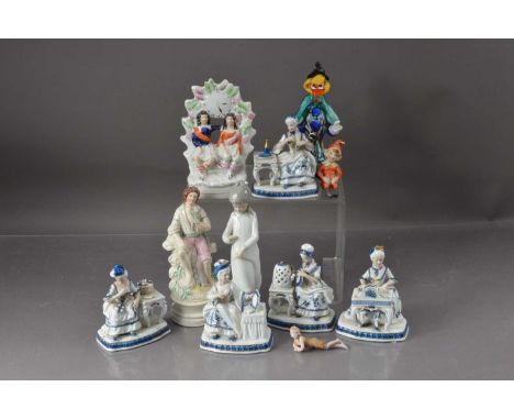 Collection of porcelain continental blue and white figures, ladies seated at dressing tables, a 19th century Staffordshire cl