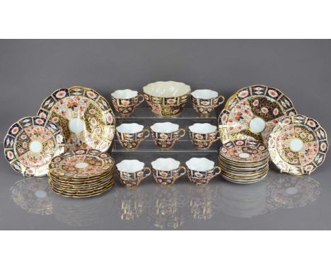 A late Victorian and later part Crown Derby Imari style porcelain tea set, with slops bowl, cracked, eight cups, three cracke