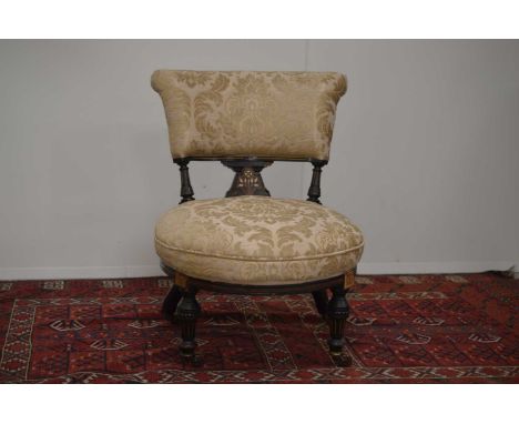 A Victorian Aesthetic Movement nursing seat English circa 1870s, ebonized spindles and legs with gilt detailing. Painted inla