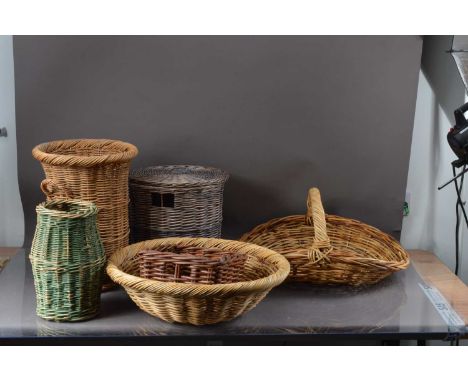 A collection of wicker baskets, including a small Ali Baber basket, an umbrella stand, green example, circular bowl, swing ha