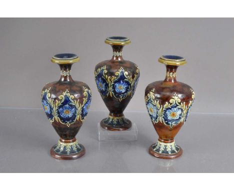 A trio of Doulton Lambeth stoneware vases, Pattern No. 9529 various impressed and scratched marks to the bases, one with repa