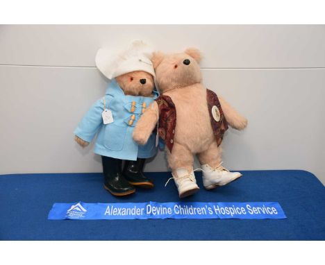 Two Paddington Teddy bears, one with modern duffel coat and Wellington boots, the other with waistcoat and later white boots,