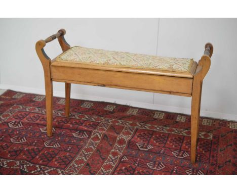 A late 19th or early 20th Century duet piano stool, of typical form, The hinged seat lifting for storage of music, 92 cm wide