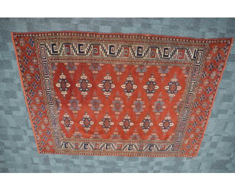 A red ground Oriental Turkaman rug, tightly woven, hand-knotted wool, the ends bound without fringe, 171 cm by 124 cm, thank 