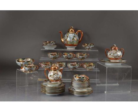 A Japanese eggshell tea set, setting for eleven cups, heightened in gilt, tea pot, sugar bowl, hot water, and slop bowl with 