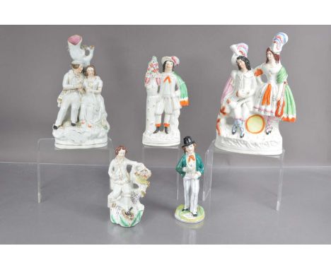 Five Victorian Staffordshire figure and figure groups, including a spill vase depicting sweethearts, a couple with a dog and 