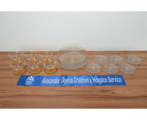 A vintage moulded glass fruit salad set, the textured bowl with six matching smaller examples together with a set of six ambe