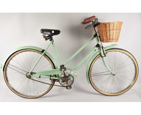 A retro Phillips lady's bicycle with wicker basket and later painted but having original bar brakes to front brakes, thank yo