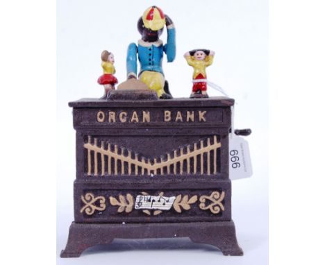 MONEY BOX: A vintage Victorian style 20th century cast iron hand painted automaton style money box in the form of a barrel or