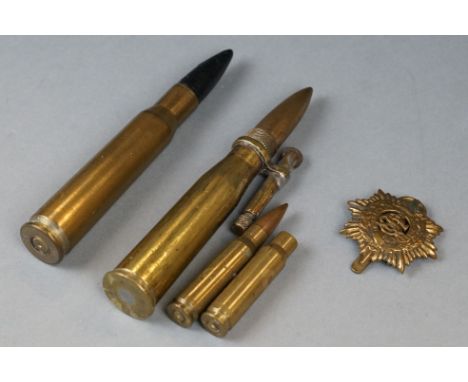 A Small Group Of Military Collectables To Include A Brass Army Service Corps Cap Badge, A Trench Art Brass Light And A Quanti