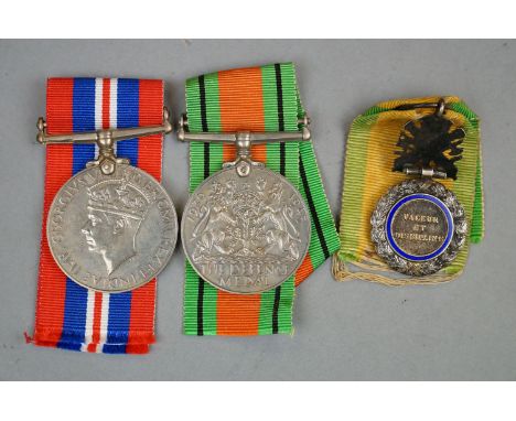 A Small Group Of Military Collectables To Include A Full Size British World War Two Defence Medal And 1939-1945 British War M