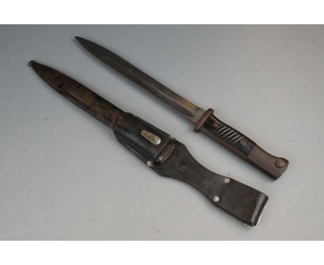 A World War Two German K-98 Bayonet Complete With Matching Numbers Scabbard And Leather Frog.