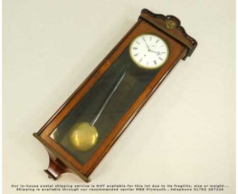 WALL CLOCK. A mahogany wall clock, the case with stamped metal decoration. Height 97cm.Please note: we cannot guarantee the c