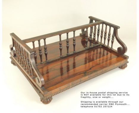REGENCY BOOK TROUGH. A Regency rosewood book trough with turned spindles, width 41.5cm. Please note: Our in-house postal serv