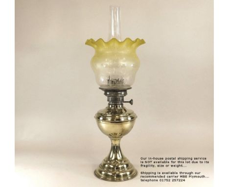 OIL LAMP. A late Victorian brass oil lamp with etched &amp; tinted shade. Height 59cm. Please note: Our in-house postal servi