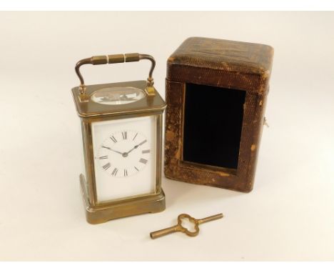 CARRIAGE CLOCK. A large brass cased carriage clock in carrying case with key. Height (handle down) 13.5cm.Please note: we can