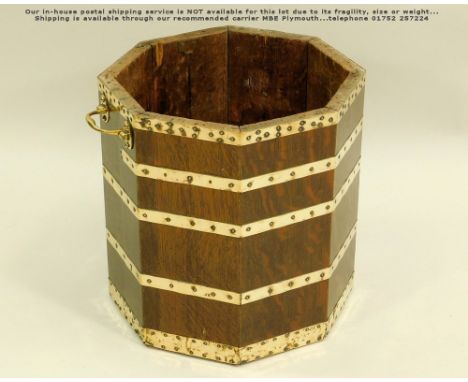 OAK PLANTER. A Victorian brass bound octagonal planter/bucket (?) with twin brass handles. Diameter 34cm, height 36cm.Please 