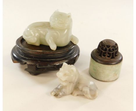 JADE ETC.A carved jade cat, 8cm, on a hardwood stand, a carved soapstone small lion & a metal lined jade box with pierced woo
