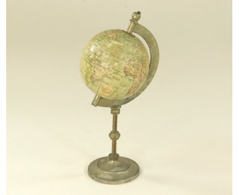 MINIATURE GLOBE. A late 19th century miniature terrestrial globe by J.L. &amp; Co., Paris, with white metal scale &amp; stand