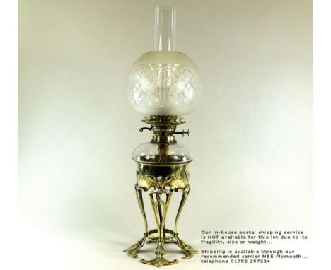ART NOUVEAU LAMP. An Art Nouveau oil lamp with brass base & etched shade. Height 62cm.Please note: Our in-house postal servic