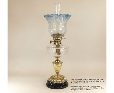 OIL LAMP. A Victorian oil lamp with cut glass fount &amp; blue etched shade. Height 63cm. Please note: Our in-house postal se