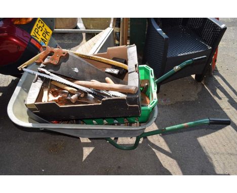 Metal garden wheelbarrow together with a large quantity of garden tools