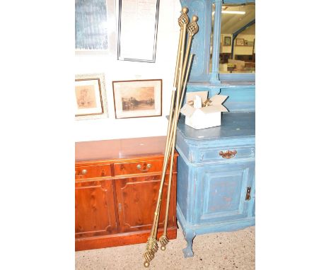 A group of metal curtain poles and fittings
