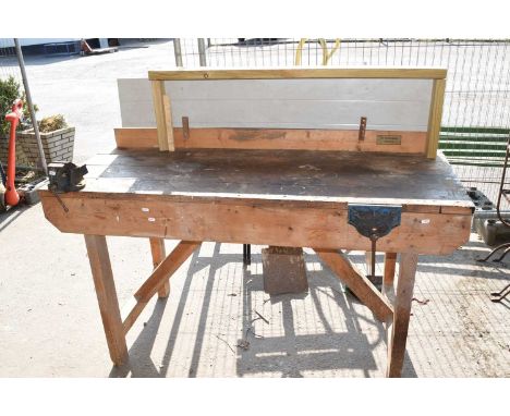 A heavy duty work bench together with two vices