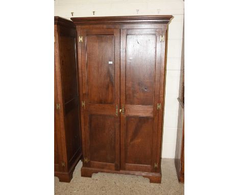 20th Century double door wardrobe by Simon Simpson of Norwich with two panelled doors, brass fittings and bracket feetDimensi