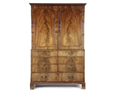A GEORGE III MAHOGANY LINEN PRESS C.1770 the detachable dentil cornice above a pair of flame mahogany doors with outline moul