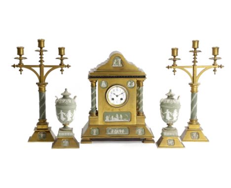 A GILT BRASS AND WEDGWOOD POTTERY MOUNTED CLOCK GARNITURE C.1870-80 the French brass drum eight day movement striking on a go