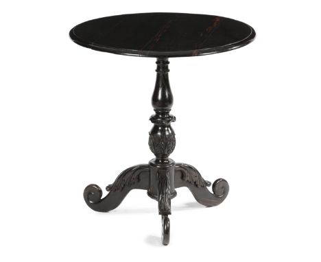 AN ANGLO-CEYLONESE EBONY TRIPOD OCCASIONAL TABLE MID-19TH CENTURY the circular fixed top with a moulded edge, on a leaf carve
