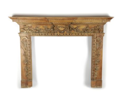 A CARVED PINE FIRE SURROUND / CHIMNEY PIECE IN GEORGE II STYLE 19TH CENTURY the breakfront mantel above leaf, ovolo and denti