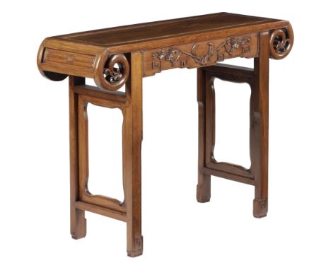 A CHINESE HARDWOOD ALTAR TABLE LATE 19TH / EARLY 20TH CENTURY the panelled top with scroll ends, carved with leaves, the frie