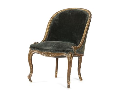 AN EARLY VICTORIAN GILTWOOD SLIPPER CHAIR C.1840-50 upholstered with green velvet, the moulded frame carved with flowers and 