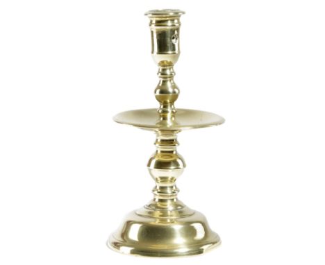 A DUTCH BRASS HEEMSKERK CANDLESTICK SECOND HALF 17TH CENTURY with a pierced socket, on a turned stem and a dished drip-pan, o
