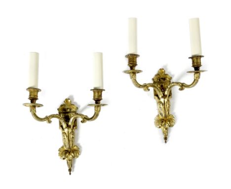 A PAIR OF FRENCH ORMOLU TWIN-LIGHT WALL LIGHTS IN REGENCE STYLE decorated with leaves, together with another pair of wall lig