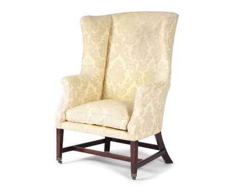 A GEORGE III MAHOGANY WING ARMCHAIR C.1780-90 upholstered with damask fabric, with scroll arms, on square tapering legs unite