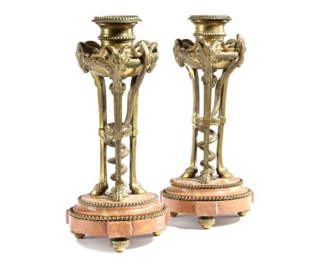 A PAIR OF FRENCH ORMOLU CANDLESTICKS IN LOUIS XVI STYLE LATE 19TH CENTURY each in the form of an athenienne wrapped with a sn