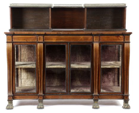 λ A LATE REGENCY ROSEWOOD BREAKFRONT SIDE CABINET EARLY 19TH CENTURY inlaid with boxwood banding, the raised bookcase back wi