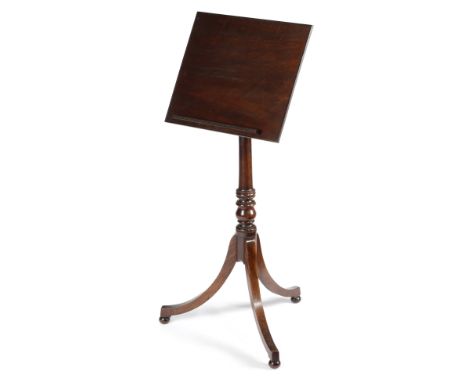 A REGENCY MAHOGANY READING TABLE C.1805-10 the hinged adjustable top with a reeded edge and a removable rest, on a turned ste