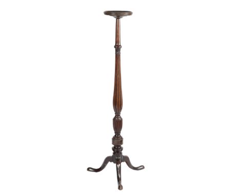 A MAHOGANY TORCHERE 18TH CENTURY ELEMENTS the circular dished top above a ribbed baluster stem, with a stiff leaf capital, on