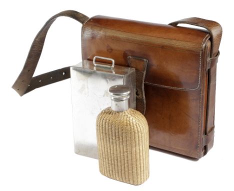 A BROWN LEATHER CAMPAIGN / HUNTING LUNCH BOX EARLY 20TH CENTURY containing: a plated sandwich tin and a wicker flask 18.5cm h