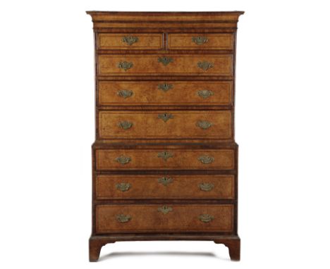 A GEORGE II BURR ELM AND WALNUT CHEST ON CHEST C.1730-40 with two short and six long cross and feather banded drawers, flanke