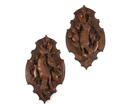 A PAIR OF BLACK FOREST LINDEN WOOD HUNTING TROPHY PLAQUES LATE 19TH CENTURY carved with dead game, one with a fawn, the other