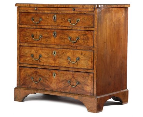 A GEORGE II WALNUT CHEST C.1730-40 the caddy moulded top quarter veneered with cross and feather banding, above a brushing sl